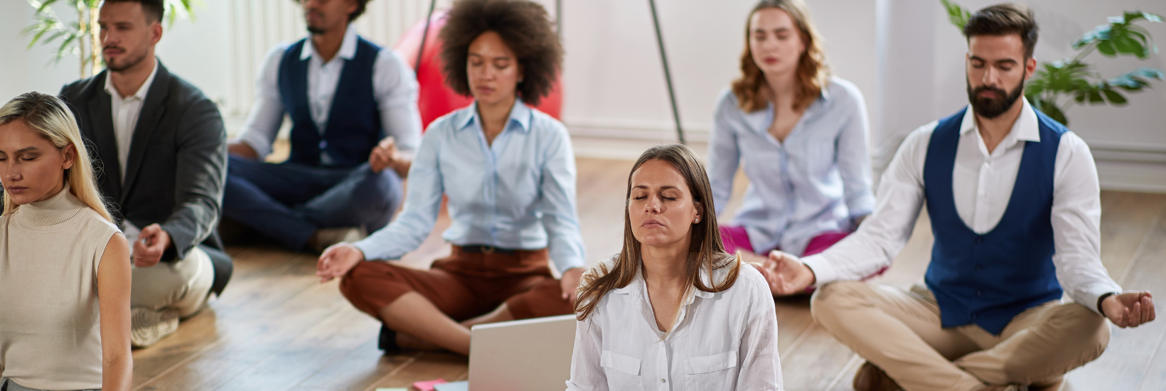 Employees engaging in a meditation session for a stress-free holiday season