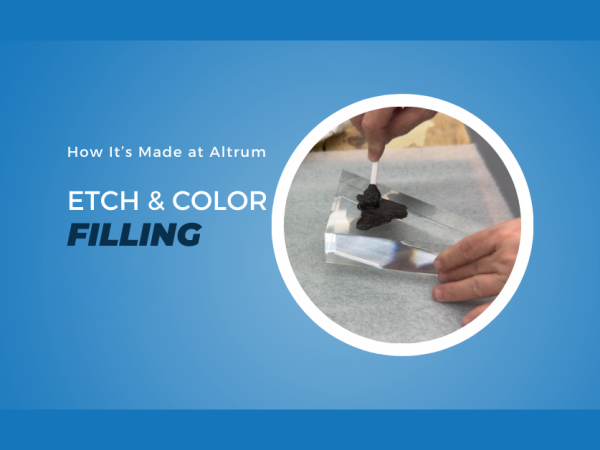 Custom award component with engraved details being colour-filled, highlighting Altrum's precision etching and finishing process.