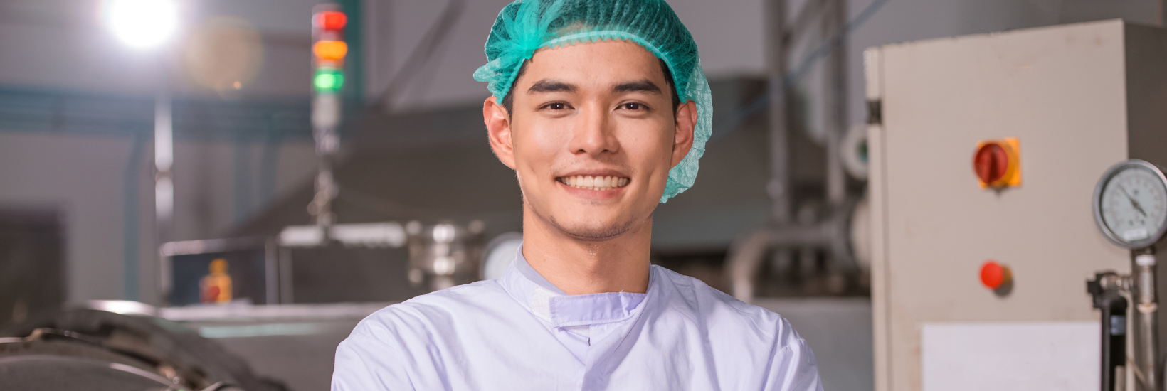 Young employee happy to be working in the food manufacturing industry