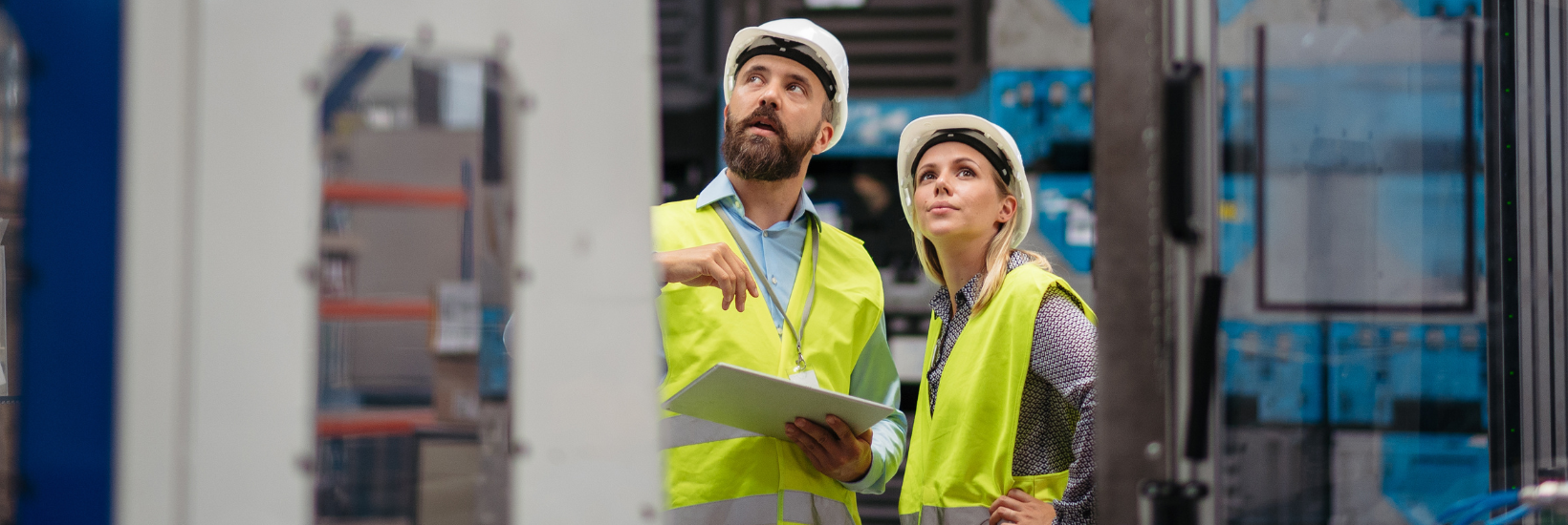 Manager and employee on the floor of a manufacturing plant
