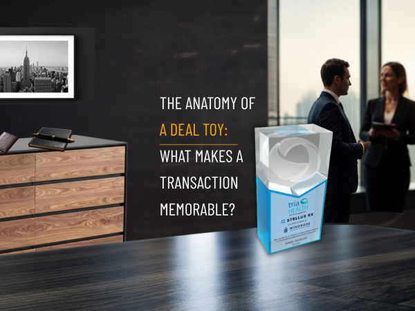 Infographic titled “The Anatomy of a Deal Toy: What Makes a Transaction Memorable?” highlighting the key elements behind a custom deal toy, including the transaction story, creative design concept, materials and craftsmanship, and the people behind the deal.